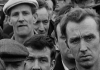 Black and white. A crowd of dock workers stand together. Black and white. A crowd of dock workers stand together.