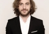 Comedian Seann Walsh wearing a black suit and standing against a neutral background Comedian Seann Walsh wearing a black suit and standing against a neutral background