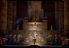 A dark set reproducing Egyptian statues and pyramids with a big ensemble in white robes A dark set reproducing Egyptian statues and pyramids with a big ensemble in white robes