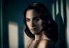 A woman with dark hair looking at the camera with shadows on her face A woman with dark hair looking at the camera with shadows on her face