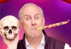 A grey-haired man with a party horn in his mouth and a skull in his hand A grey-haired man with a party horn in his mouth and a skull in his hand