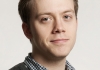 Image of Owen Jones wearing a checked shirt and a dark jumper against a neutral background Image of Owen Jones wearing a checked shirt and a dark jumper against a neutral background