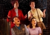 Four actors on stage looking up at fake snow falling down Four actors on stage looking up at fake snow falling down