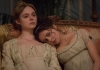 An image of two young women in Victorian dress, sitting together on a settee An image of two young women in Victorian dress, sitting together on a settee