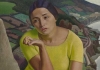A painting of a woman in a yellow shirt in front of hills of countryside A painting of a woman in a yellow shirt in front of hills of countryside