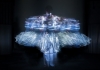 A woman on a dark stage is obscured by a mirage of neon lights A woman on a dark stage is obscured by a mirage of neon lights
