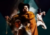 The cast of Fagin's Twist, in Victorian dress and top hats, under bright lights The cast of Fagin's Twist, in Victorian dress and top hats, under bright lights