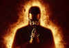 Comedian Romesh Ranganathan wears black and looks down, silhouetted against a bright, flaming background. Comedian Romesh Ranganathan wears black and looks down, silhouetted against a bright, flaming background.